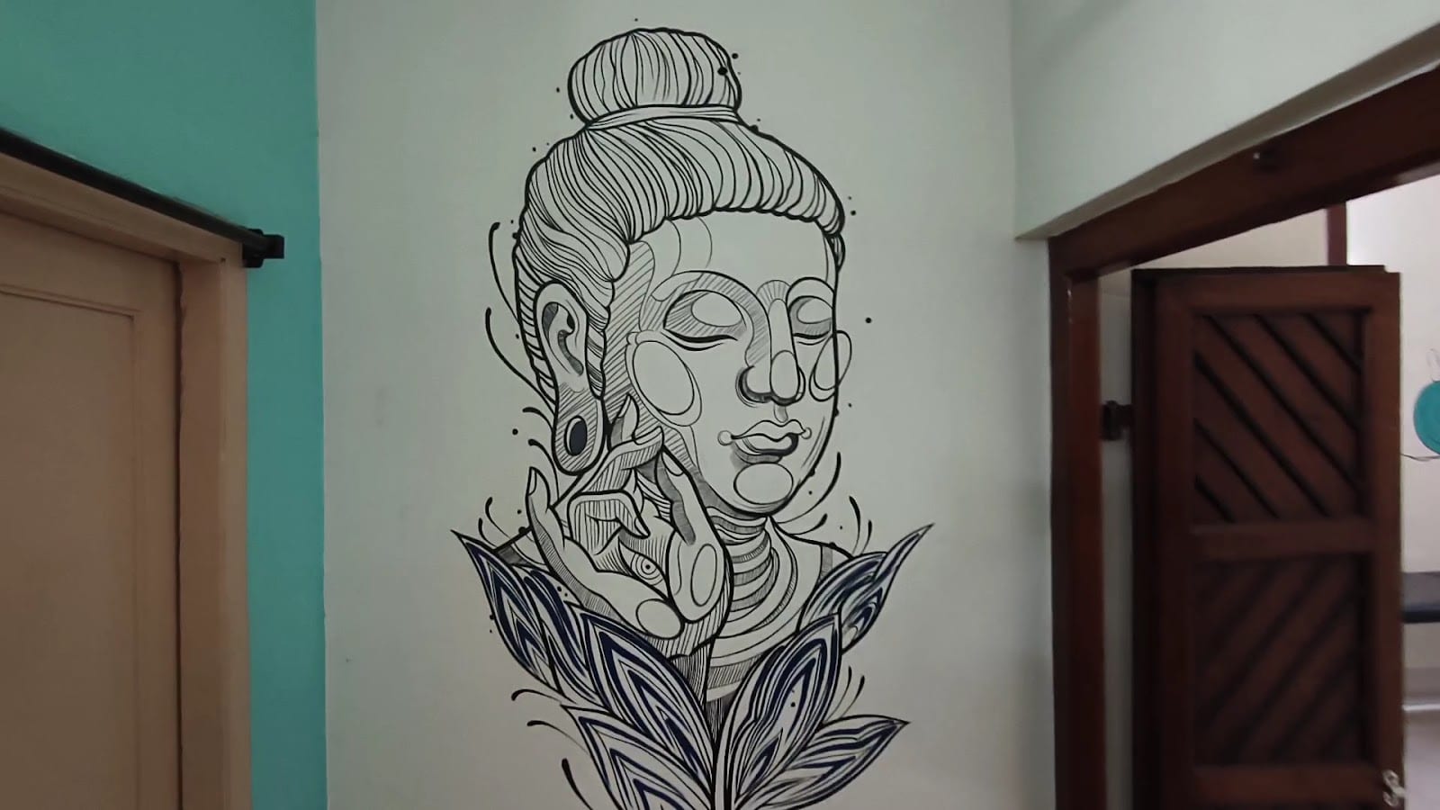 Clinic corridor with a hand-drawn Buddha and lotus wall mural